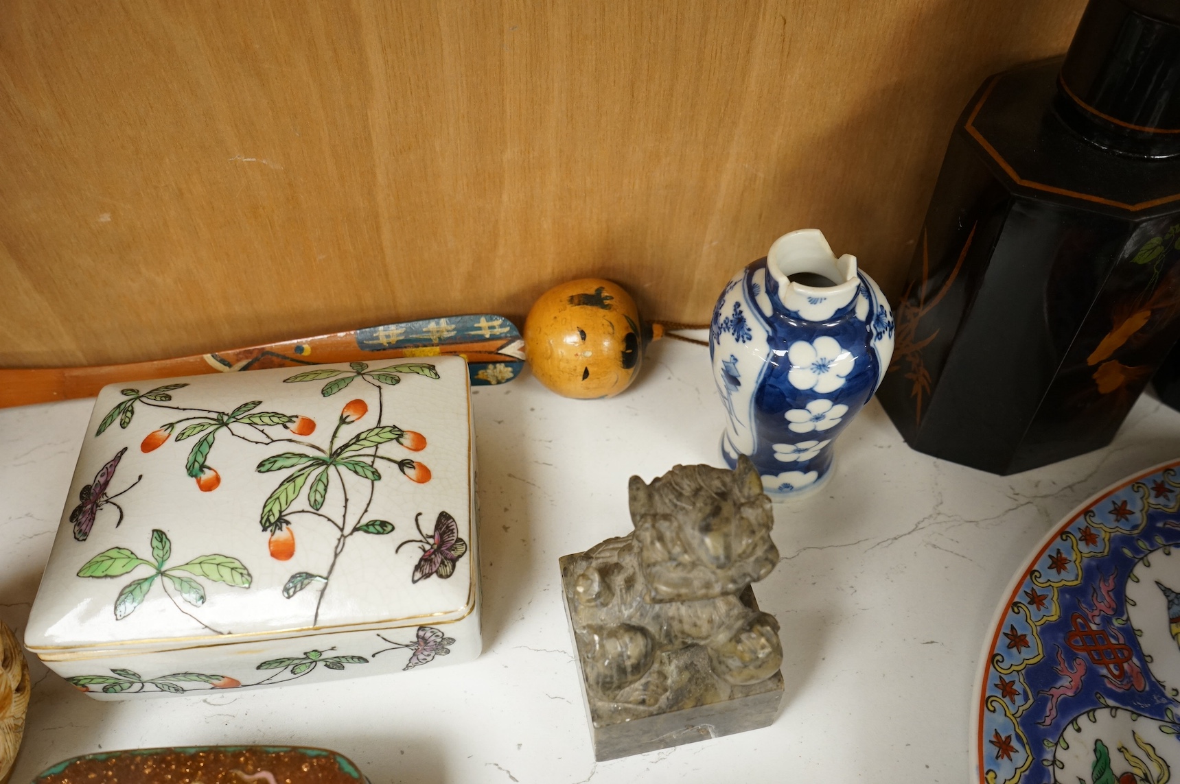 A group of mixed Chinese and Japanese ceramics to include soapstone carvings, prunus flower ginger jars, rose quartz Buddha and pair of famille rose bowls. Condition - varies, mostly fair/good